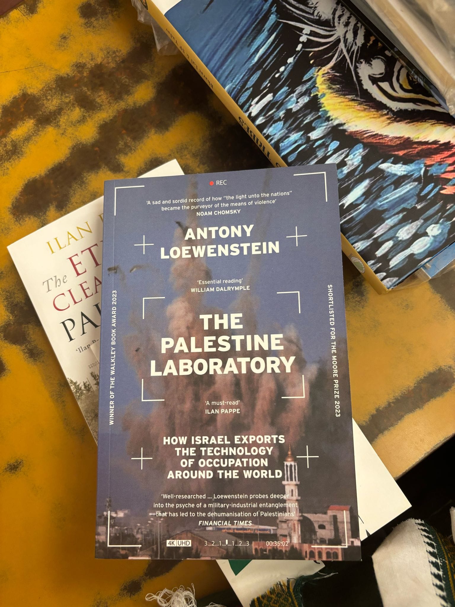 The Palestine Laboratory by Antony Loewenstein is pictured sitting on a table.